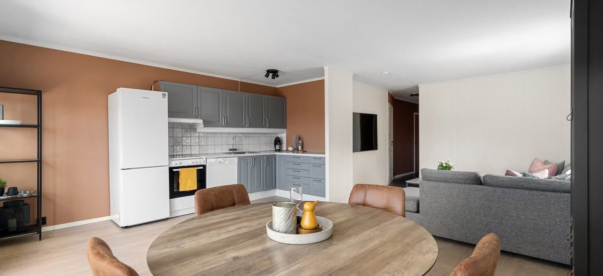 A contemporary open-plan kitchen and dining area with modern minimalist design elements in a stylish apartment.